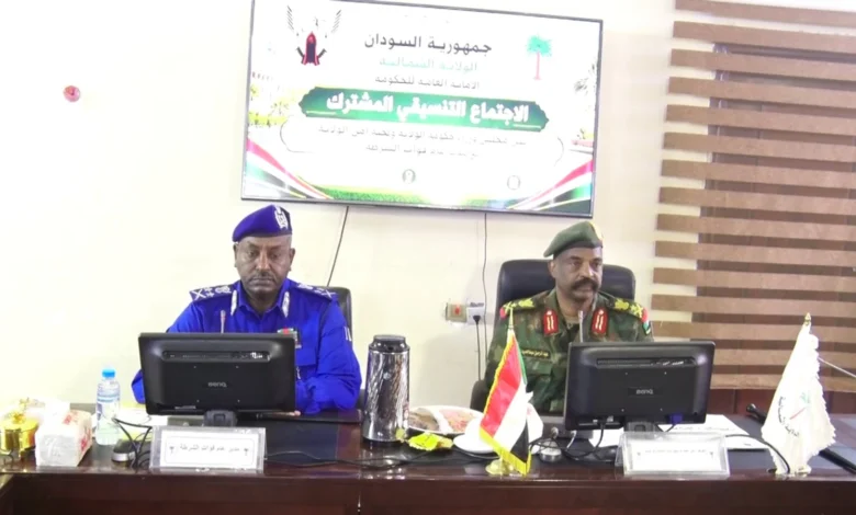 مسؤولان أمام منصة ولافتة في لقاء للشرطة