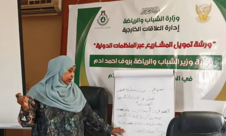 مشاركة في ورشة أمام لافتة تدريب على صياغة المشروعات